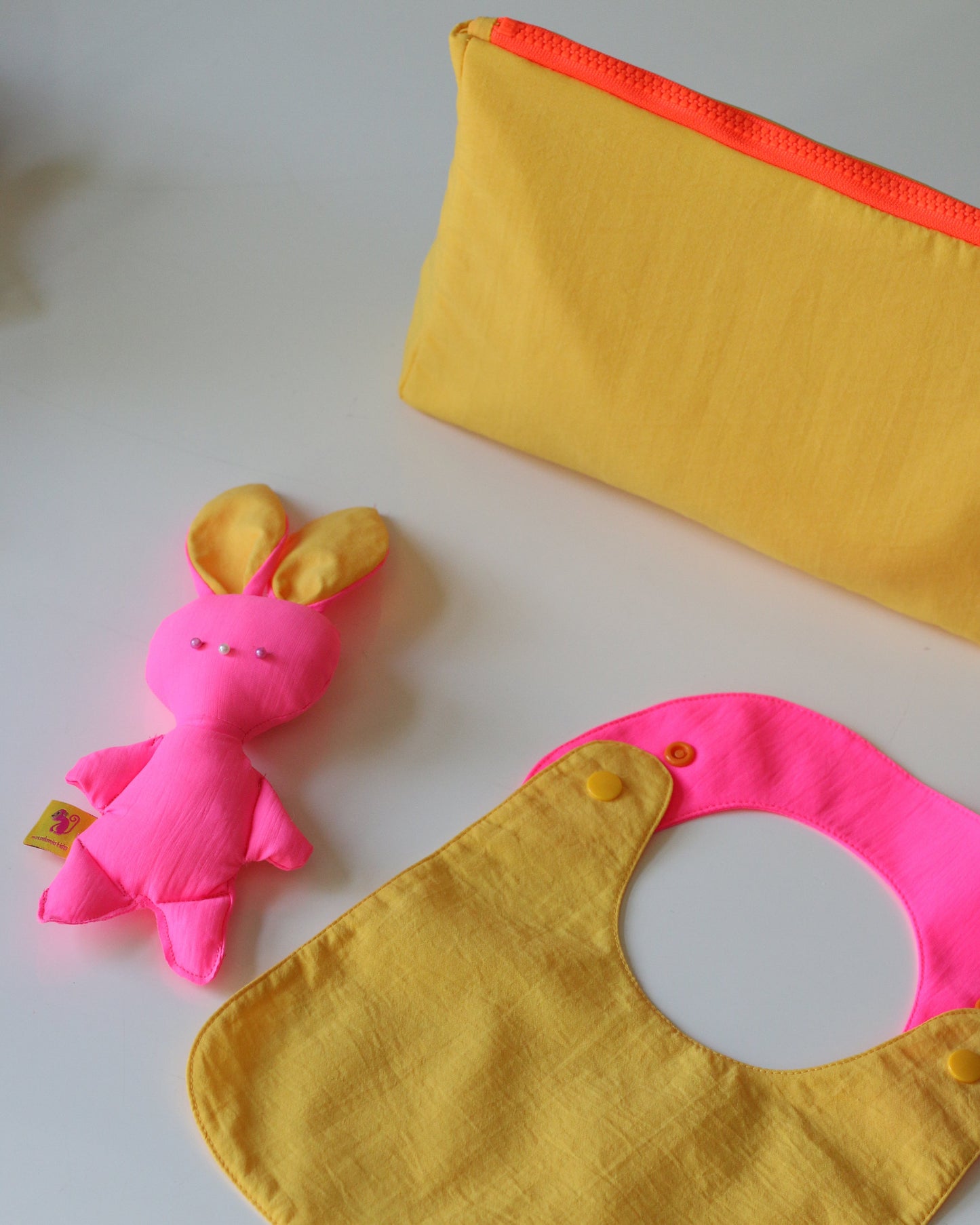 Reversible yellow/fuchsia bib