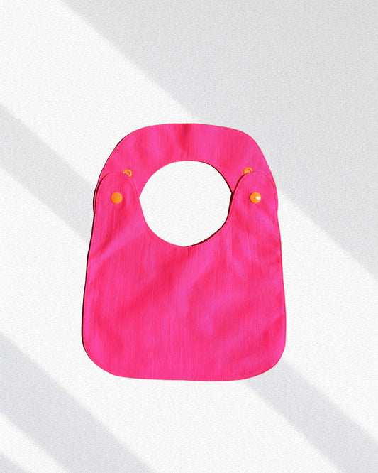Babero reversible fucsia