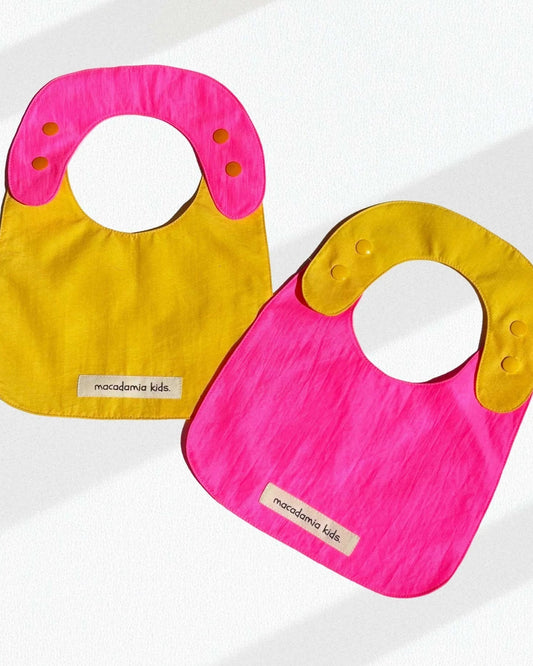 Pack de 2 baberos reversibles amarillo/fucsia