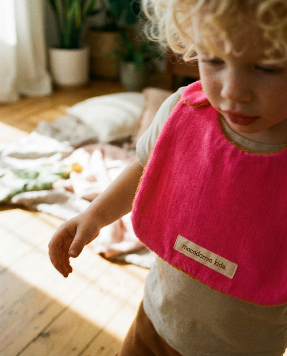 Reversible orange/fuchsia cotton terry bib