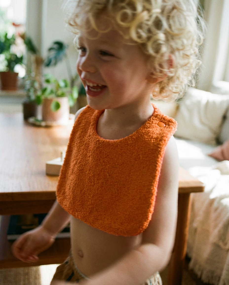 Reversible orange/fuchsia cotton terry bib