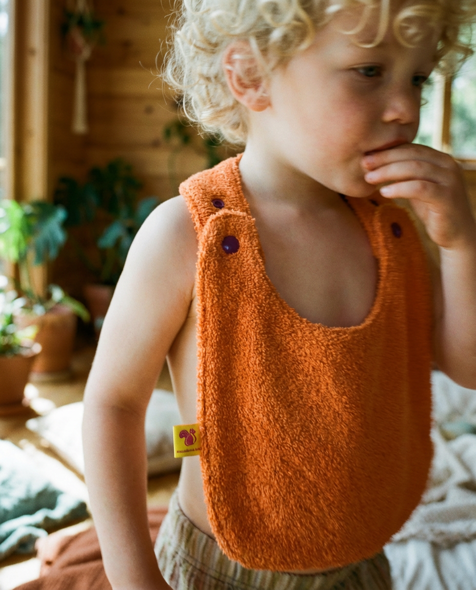 Babero reversible rizo naranja/muselina malva