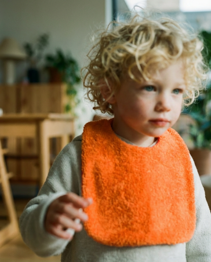 Reversible orange/fuchsia cotton terry bib