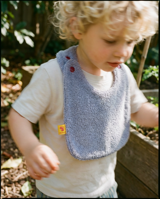 Babero reversible rizo lila/tejido técnico lila