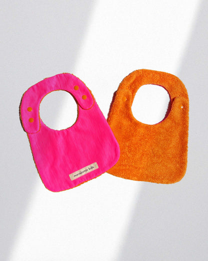 Babero reversible naranja/fucsia rizo de algodón