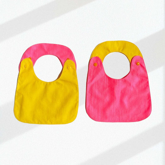 Pack de 2 baberos reversibles amarillo/fucsia