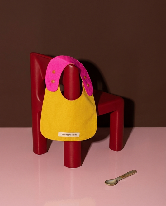 Babero reversible amarillo/fucsia